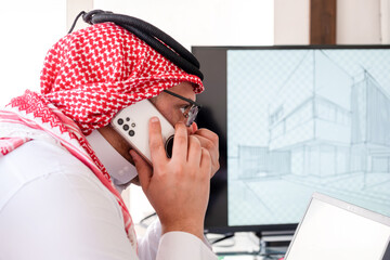 arabic male using phone during work to make sure it is flow is in the right direction - obrazy, fototapety, plakaty