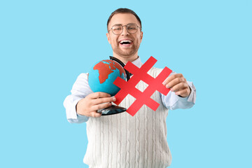 Male Geography teacher with globe and hashtag on blue background