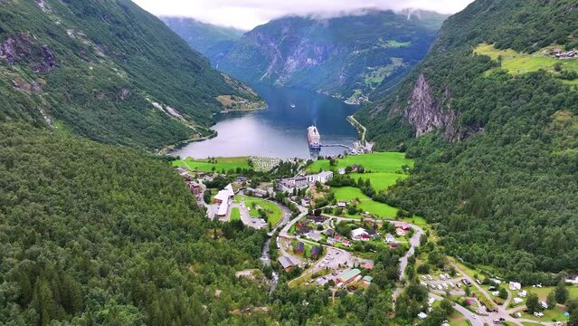 Geiranger, Norway. Aerial View of Picturesque Village and Fjord, Popular Cruise Ship Tourist Destination, Drone Shot 60fps