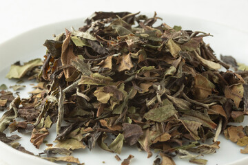 A closeup view of a pile of pa mu tan loose leaf tea.