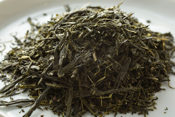 A closeup view of a pile of loose leaf kabusecha green tea.