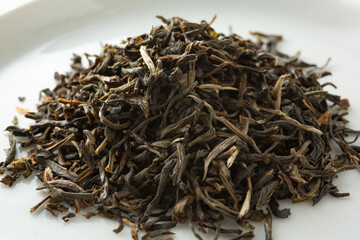A closeup view of a pile of loose leaf jasmine green tea.