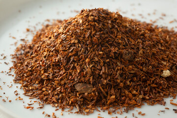 A closeup view of a pile of loose leaf rooibos herbal tea blend.