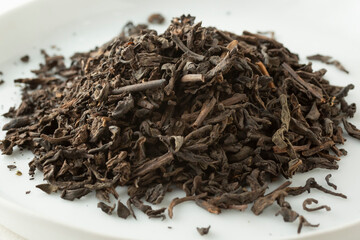 A closeup view of a pile of loose leaf pu-erh tea.