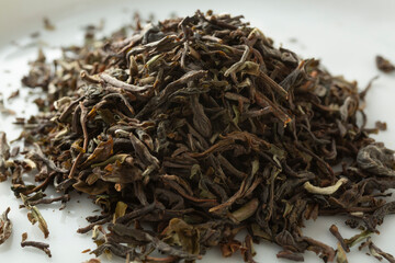 A closeup view of a pile of loose leaf Singbulli Estate Darjeeling black tea.