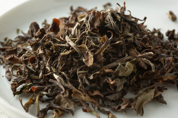 A closeup view of a pile of loose leaf Darjelling oolong tea.