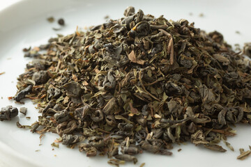 A closeup view of a pile of loose leaf Moroccan mint green tea.