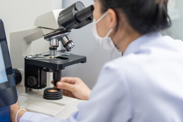 Medical doctor or scientist working in the laboratory. Using a microscope for research detect the...