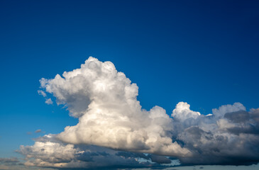 Cumulus white clouds in a blue sky.