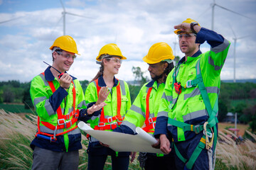 Wind turbine Engineer team working in wind turbine farm, join hands in unity