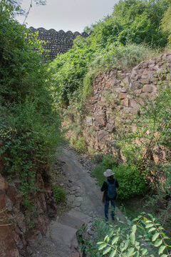 Female solo Indian tourist at Hathi nahar, Elephant gully or Rainwater gully to channel rainwater to lakes of Mehrangarh fort, at Rao Jodha Desert Rock Park, Jodhpur, Rajasthan, India. Solo tourism.
