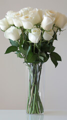 Obraz premium White fresh and elegant, long stem white roses in a glass tall vase