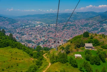 Poster Trebevic gondola raising from the old town of Sarajevo, Bosnia and Herzegovina © dudlajzov