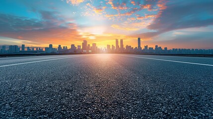 Empty asphalt road and city skyline with blue sky at sunset background, panoramic view of urban...
