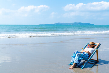 Happy Asian woman relax and enjoy outdoor lifestyle travel nature ocean on summer holiday vacation....