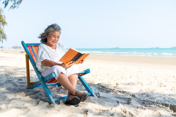 Happy Asian senior woman travel nature ocean on summer beach holiday vacation. Healthy elderly...
