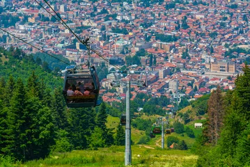 Foto auf Acrylglas Trebevic gondola raising from the old town of Sarajevo, Bosnia and Herzegovina © dudlajzov