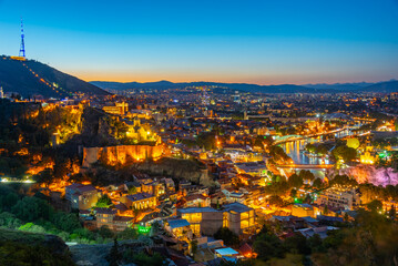 Sunset view of Narikala fortress overlooking downtown Tbilisi in Georgia © dudlajzov