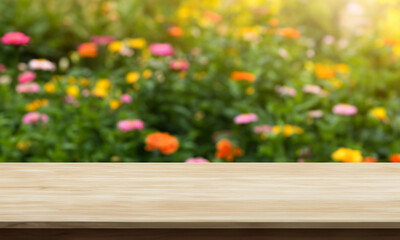 natural horizontal wood table background with flower garden behind