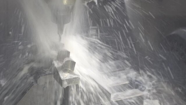 The 5-axis CNC milling machine  cutting the water turbine parts with water base coolant method.