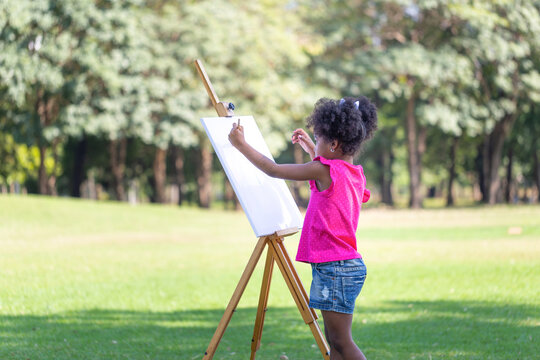 Crafts and DIY with people, Kid girl painting in the park