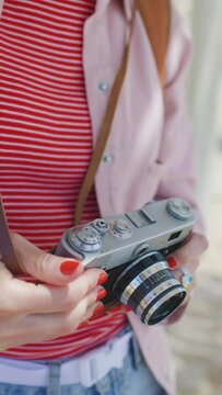 girl with a camera. stylish girl with a film camera. film camera close up. adventures and travel.