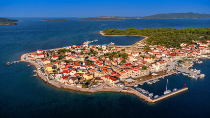 Krapanj, Croatia - Aerial view of Krapanj island (Otok Krapanj), the smallest inhabited island in Croatia. Yachts, red rooftops and clear blue sky on a sunny summer morning by the Adriatic sea