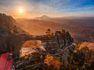 Hrensko, Czech Republic - Aerial panoramic view of the beautiful Pravcicka Brana (Pravcicka Gate) in Bohemian Switzerland National Park, the biggest natural arch in Europe with a warm autumn sunrise