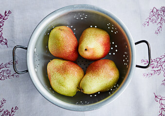 Food, fruits or bowl of pears in kitchen for fiber, organic or balanced diet for nutrition, meal or vitamin c. Background, above and healthy natural ingredients for vitamins, fresh or raw produce
