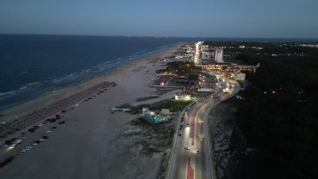 A beautiful night at the stunning Miramar Beach in Mexico, bustling with car movement.