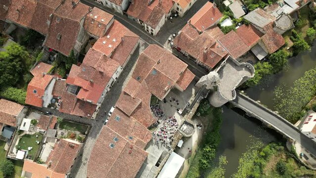 Top Down Zoom out Aerial View of Medieval French City With Open Air Theater and Green River