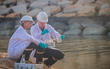 Scientist factory wearing protective uniform and glove under working water analysis and water...