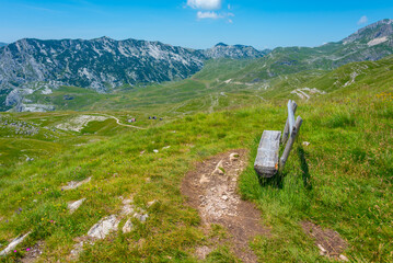 Bench at Durmitor national park viewed behind a meadow, Montenegro