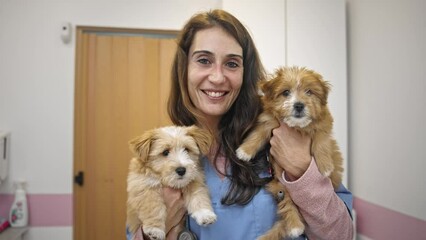 little dog visit veterinary clinic. Animal health care. Smiling veterinarian woman look at camera portrait. Nurse hold cute doggy. Pet vet job. Person check up puppy. Girl hug pup at healthcare lab.