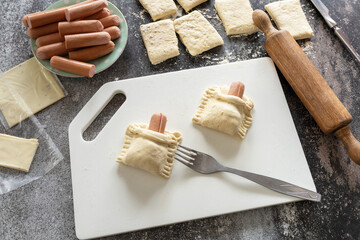 Cooking Easter rabbit-shaped buns puff pastry from sausage and cheese, step by step, step 4. - 779401697