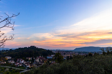 Gorizia Castle seen from the top of the hill over Nova-Gorica in Slovenia. Quiet day, relaxing places in the greenery, panorama with sunset and warm-colored clouds. Cultural Heritage Capital 2025.