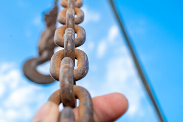 Old rusty metal chain hanging, Rusty chain links outdoors in close up,