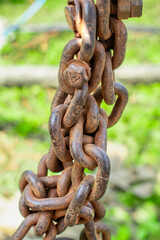 Old rusty metal chain hanging, Rusty chain links outdoors in close up,
