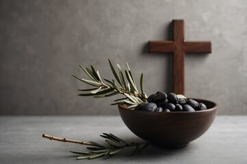 Wooden bowl with olives on a table with a cross