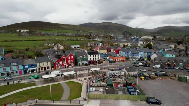 Dingle Ireland reverse drone flyaway of town on peninsula overcast spring day