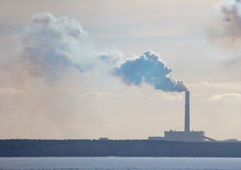 Smoke from the chimneys of a metallurgical plant in winter