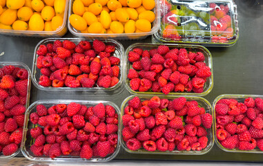 Fresh raspberries on the counter in the market