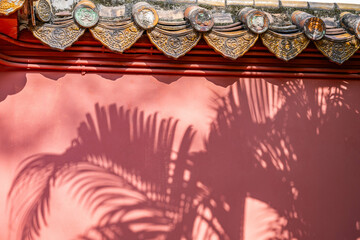 Classic red wall scattered bamboo leaves silhouette wall background