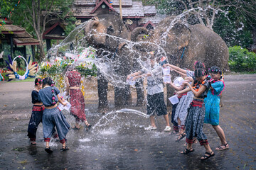 Songkran Festival Thai dress. Asian young travel group wearing colorful Thai dress costumes...