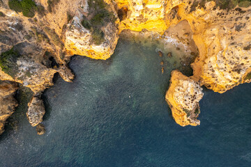 Sunrise over Ponta de Piedade, Algarve cliffs on coastline. Aerial drone view - 779410070