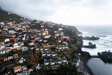 Aerial drone view  of the coast of Seixal at cloudy dramatic weather, Madeira, Portugal, Europe - 779410443
