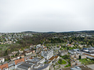 Aerial view over Swiss City of Zürich with hospital buildings and woodland in the background on a...