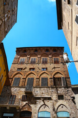 Fototapeta premium Historic house in a small alley in the city of Siena, Tuscany, Italy