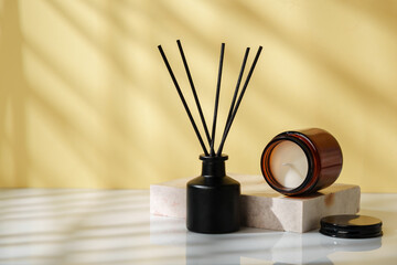 Elegant Reed Diffuser and Scented Candle on a Modern Desk at Golden Hour