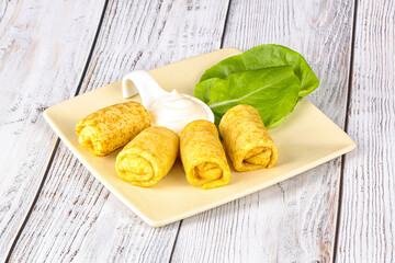 Stuffed pancakes with cream sauce
